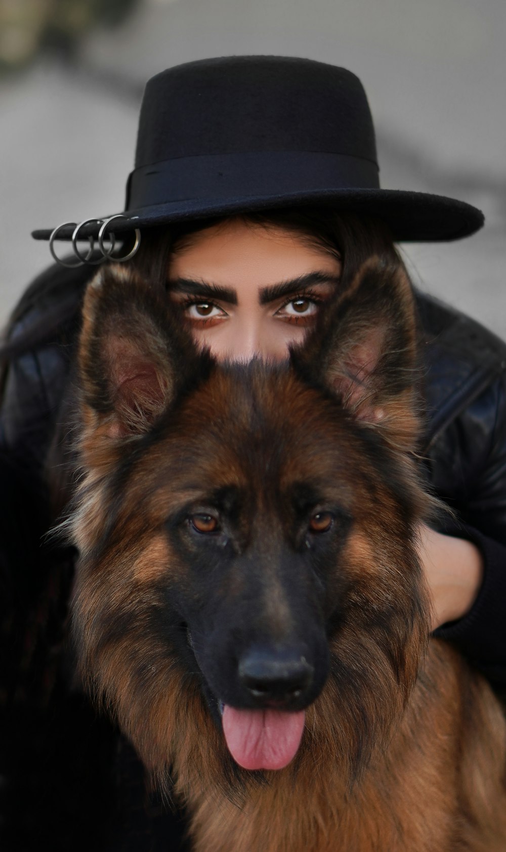 woman in black leather jacket wearing black hat