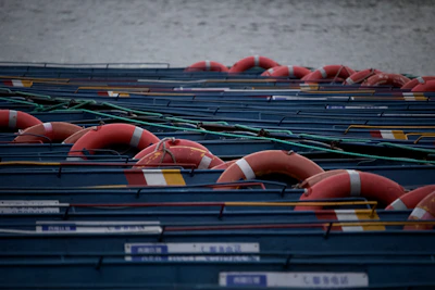 A group of naval trainees practicing man-overboard drills with lifebuoys.