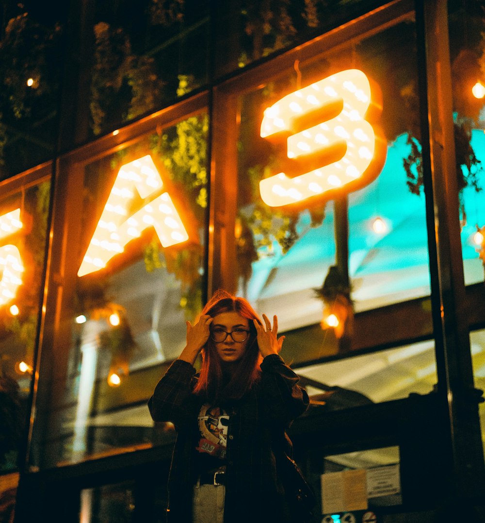 woman in black jacket wearing black framed eyeglasses