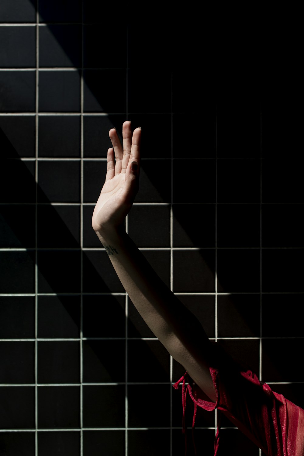 persons left hand on white and black checkered textile