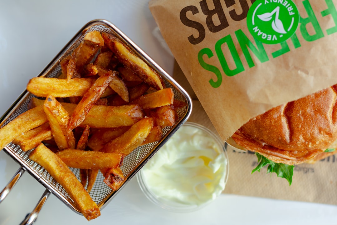 fried fries and sliced lemon on white ceramic plate