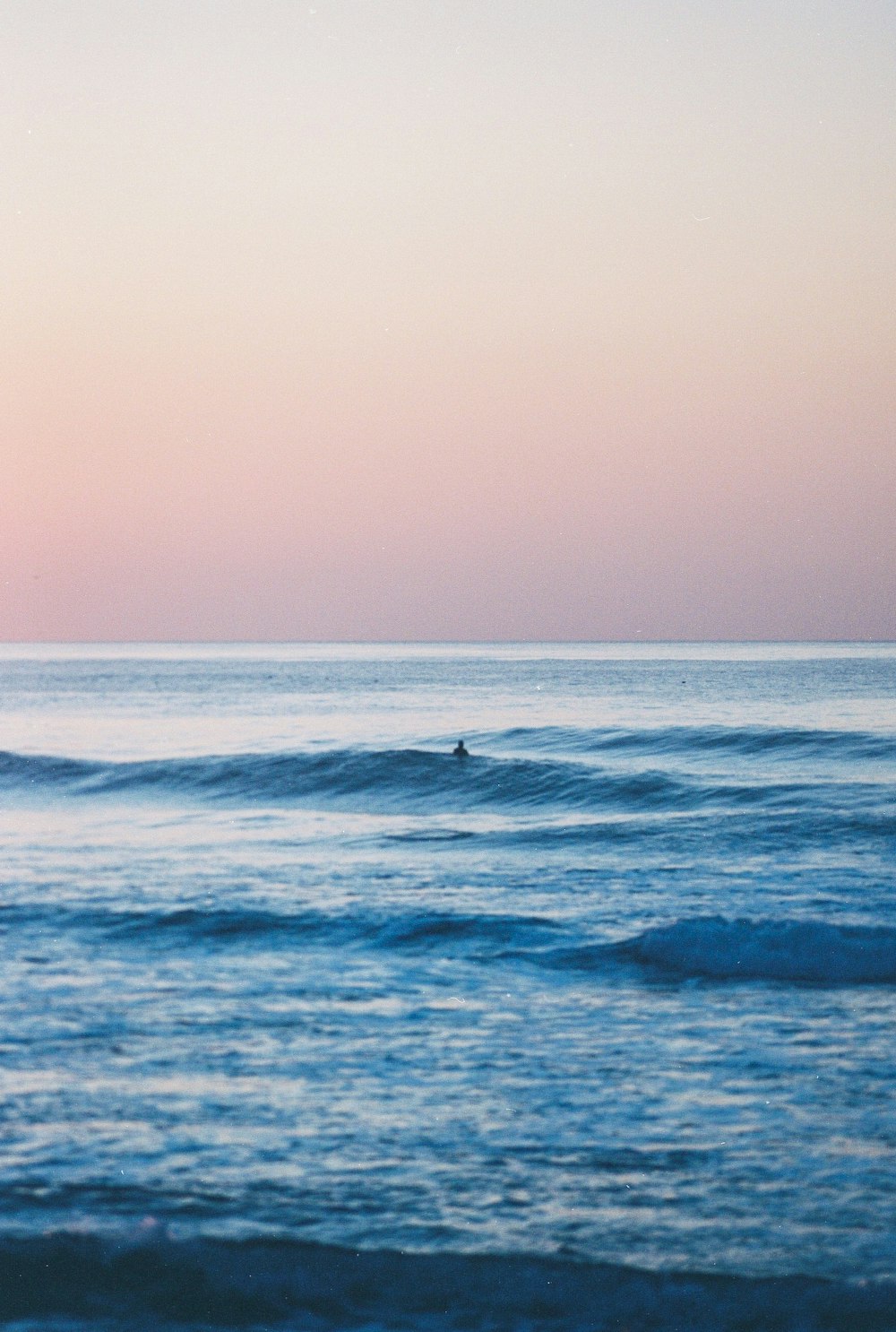 person surfing on sea waves during daytime