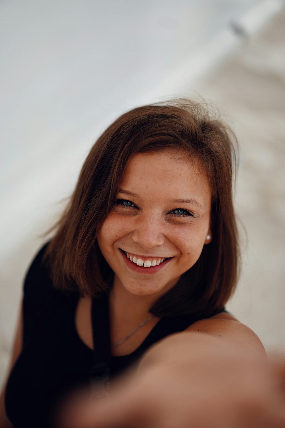 smiling woman in black tank top