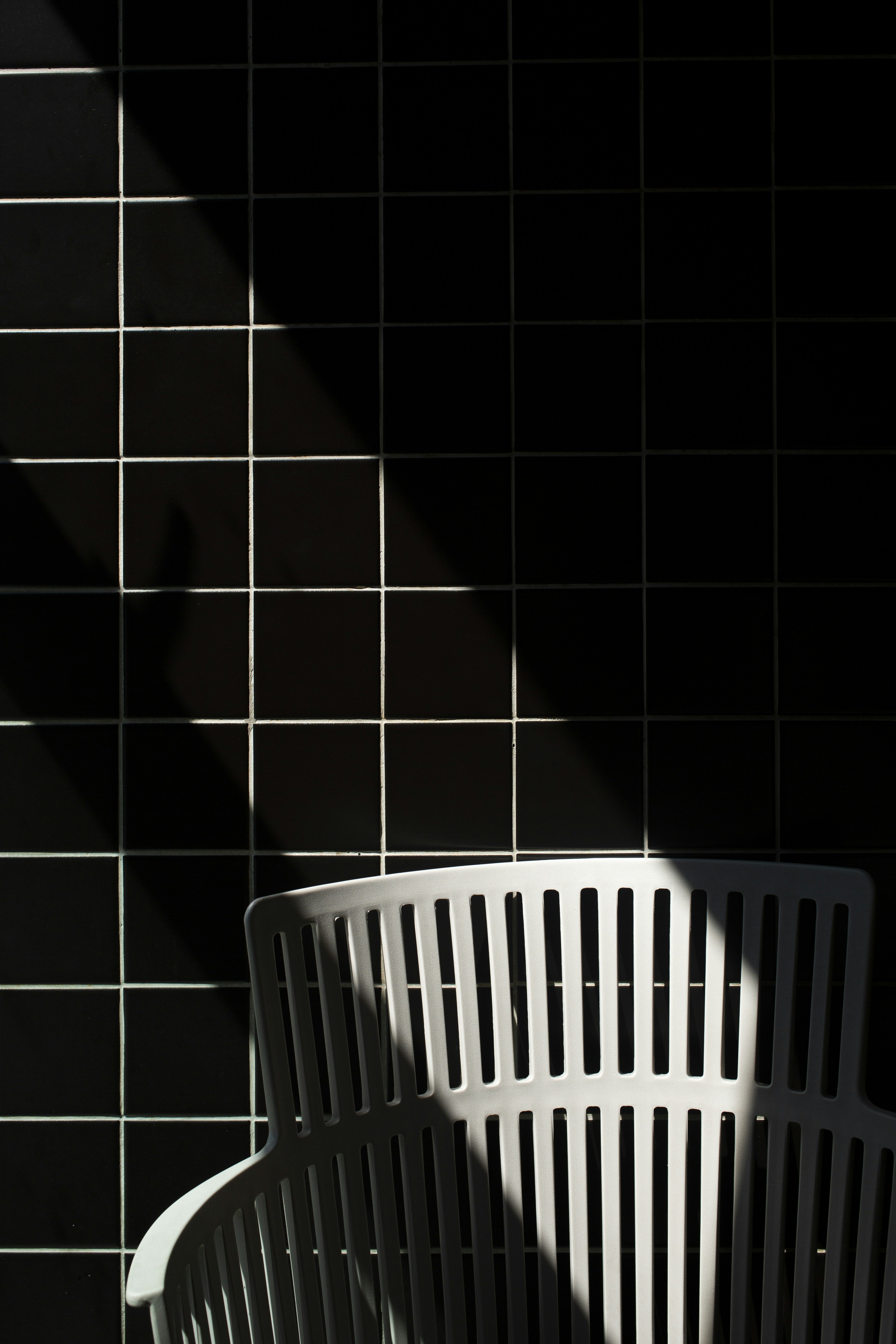 White Plastic Laundry Basket On Black Floor Tiles Photo Free Image On Unsplash