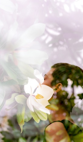 woman standing near white flowers, receiving personal healing