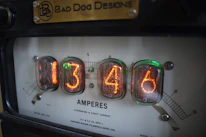 Close-up of electrical measurement instruments displaying readings.