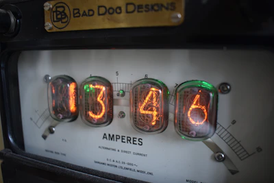 Close-up of hands using a multimeter to measure current on a simple circuit.