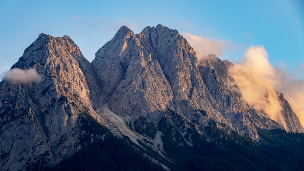 gray rocky mountain under blue sky during daytime