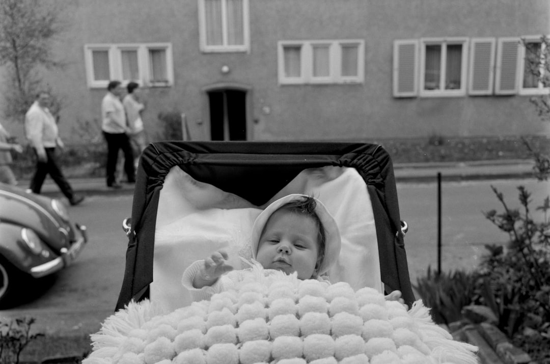 grayscale photo of baby in stroller