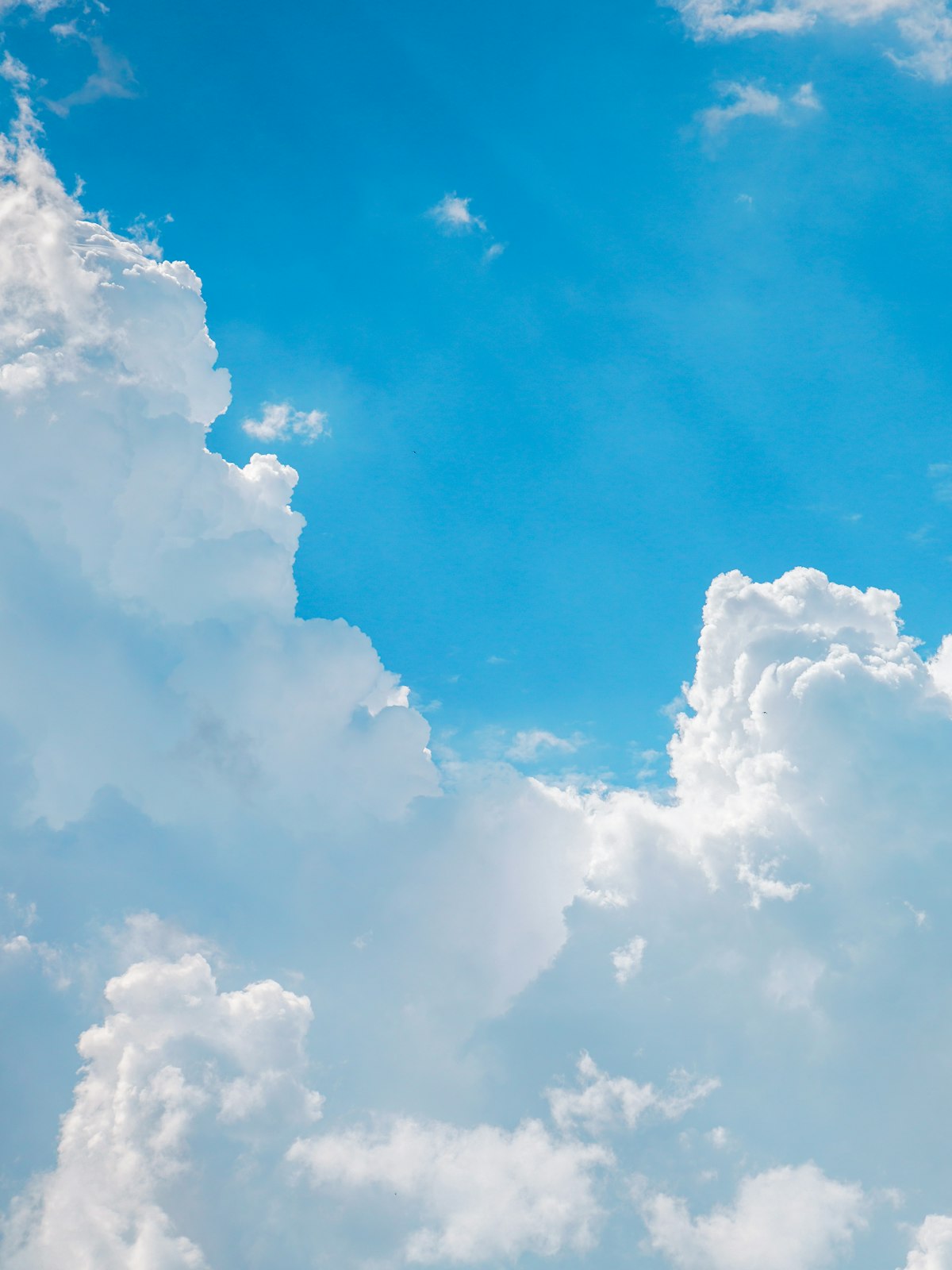 White clouds drifting across a clear blue sky.