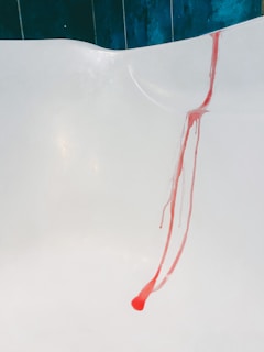 A hand safely applying the stain remover on a delicate kitchen tile.