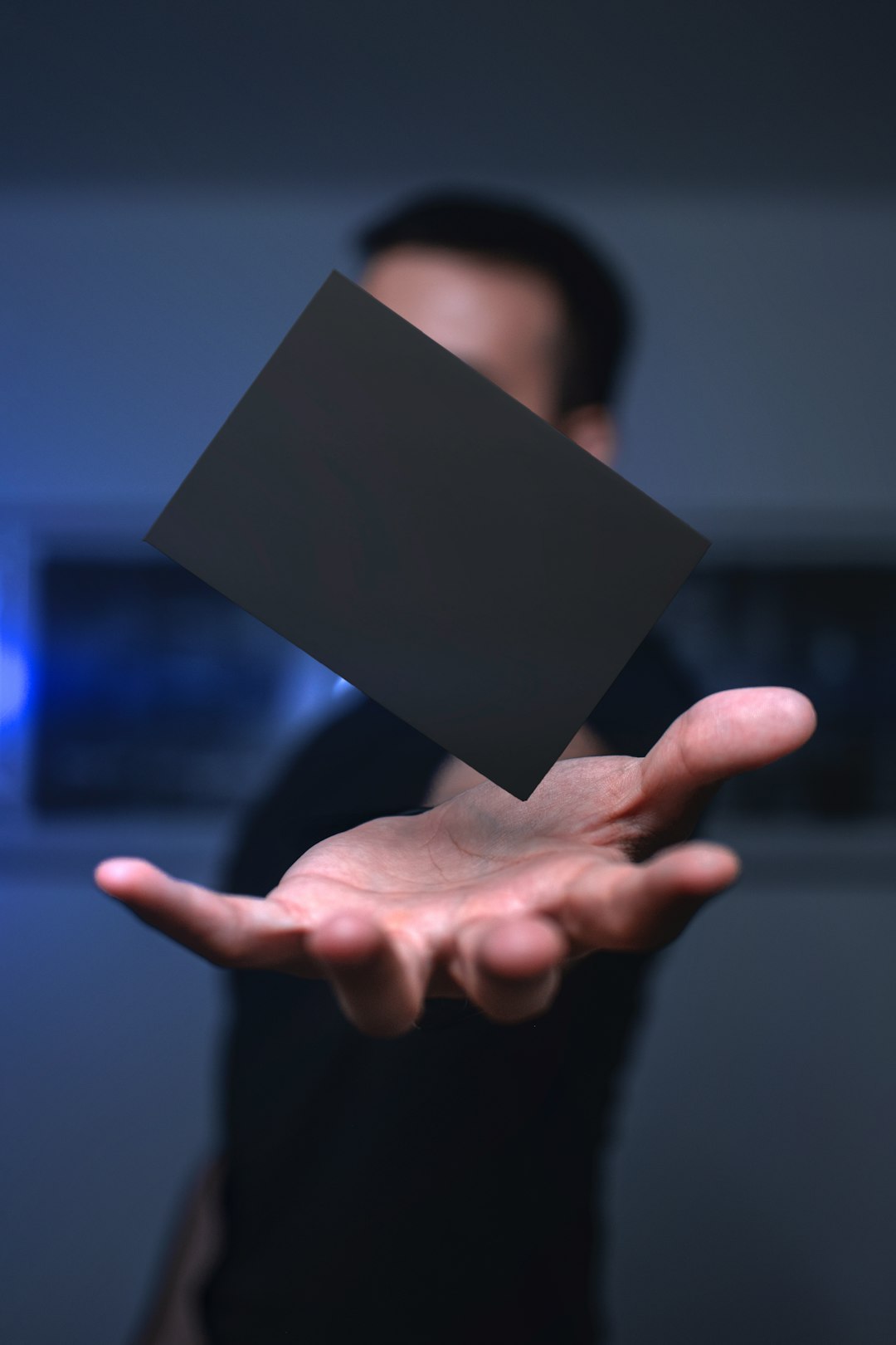 person holding black rectangular paper