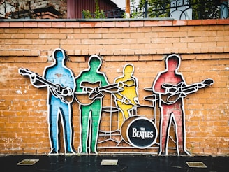 man in blue shirt and black pants standing on brown wooden ladder