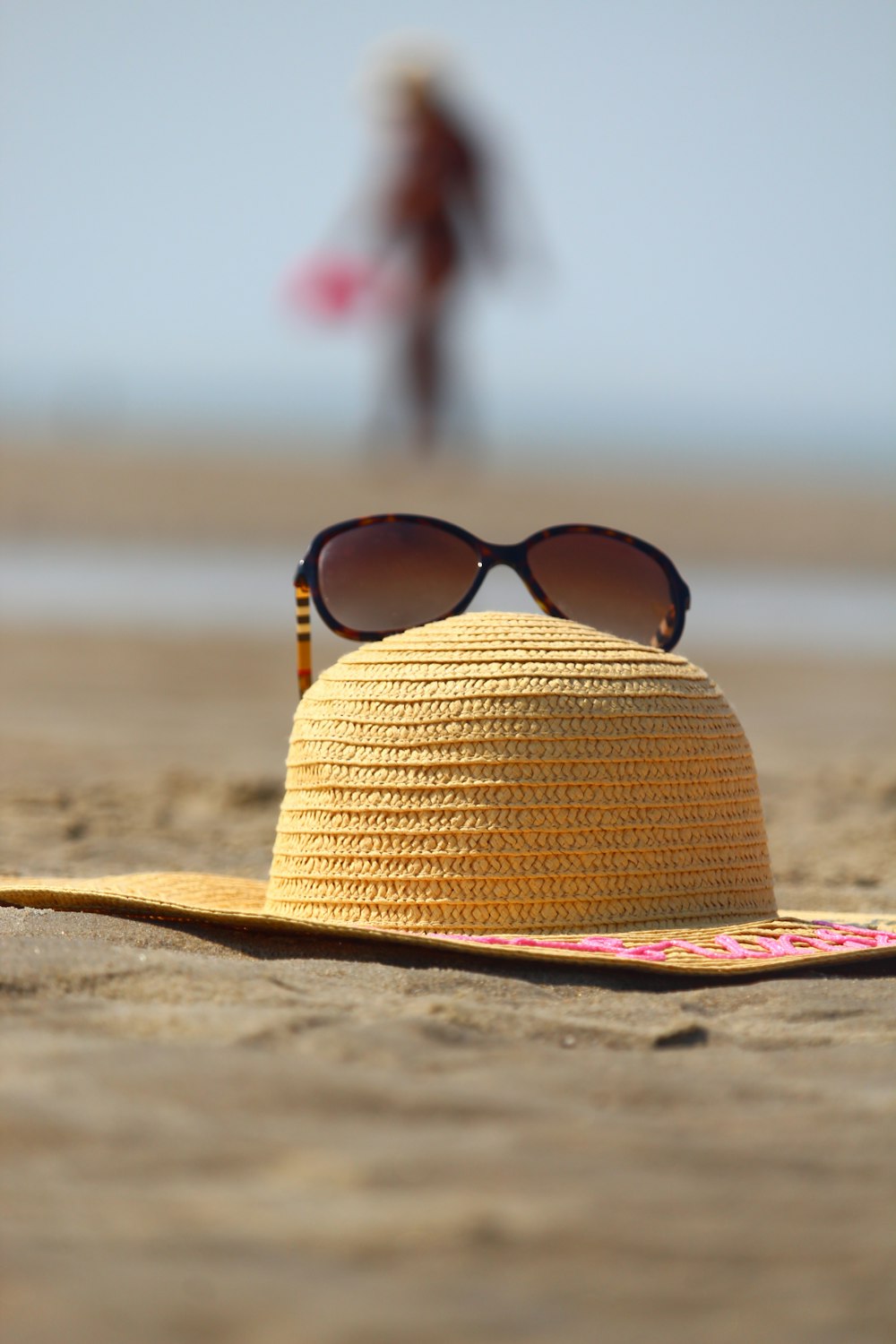 brown sun hat on beach during daytime