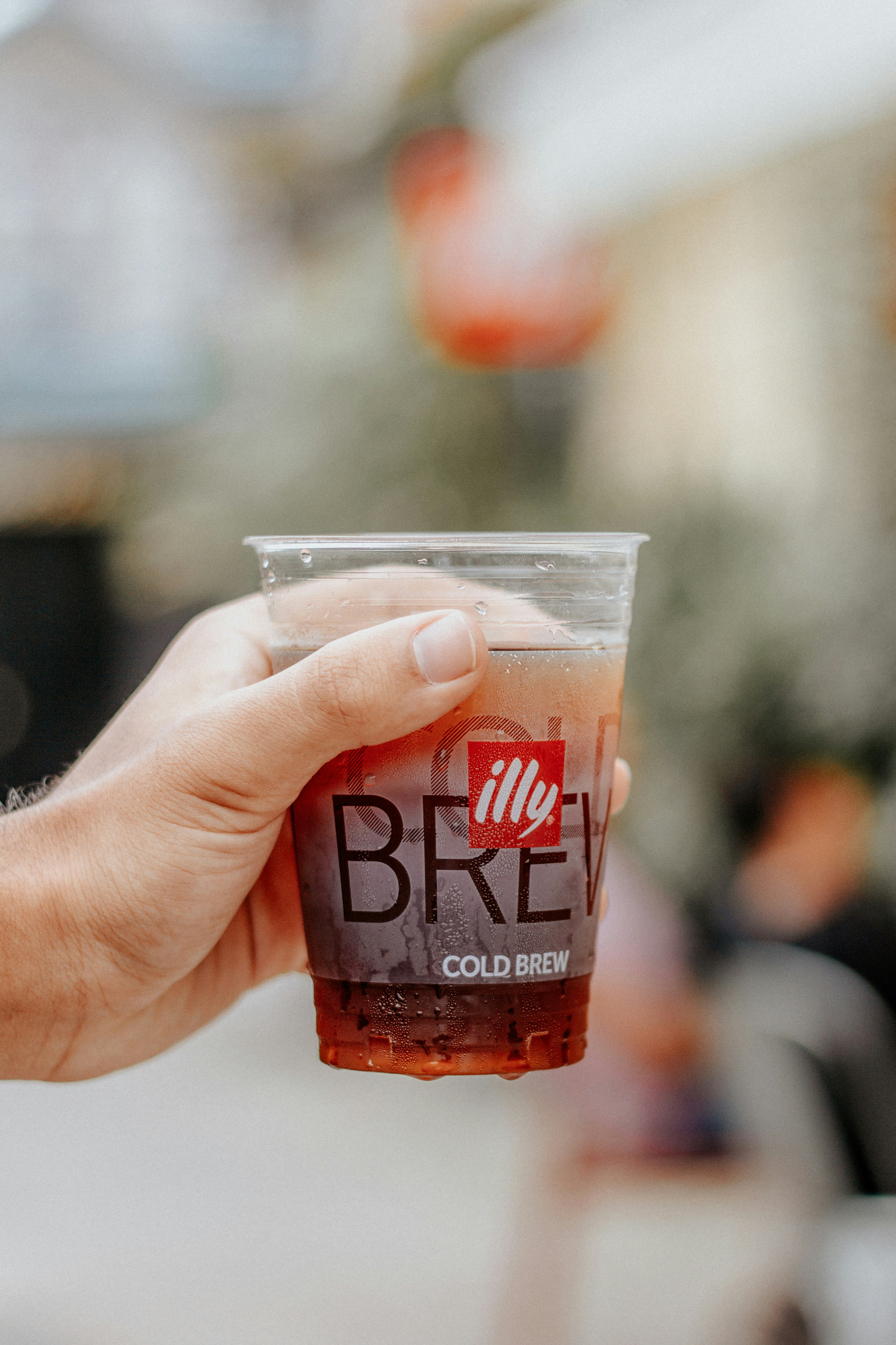 Person mit Dunkin Donuts Cup