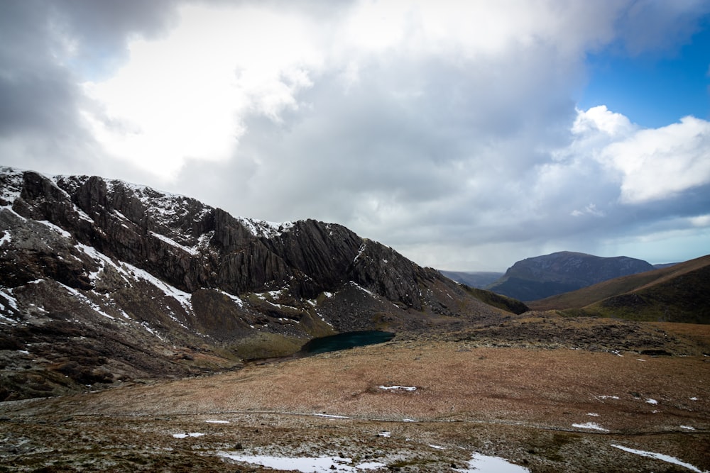 brown and gray mountains under white clouds during daytime