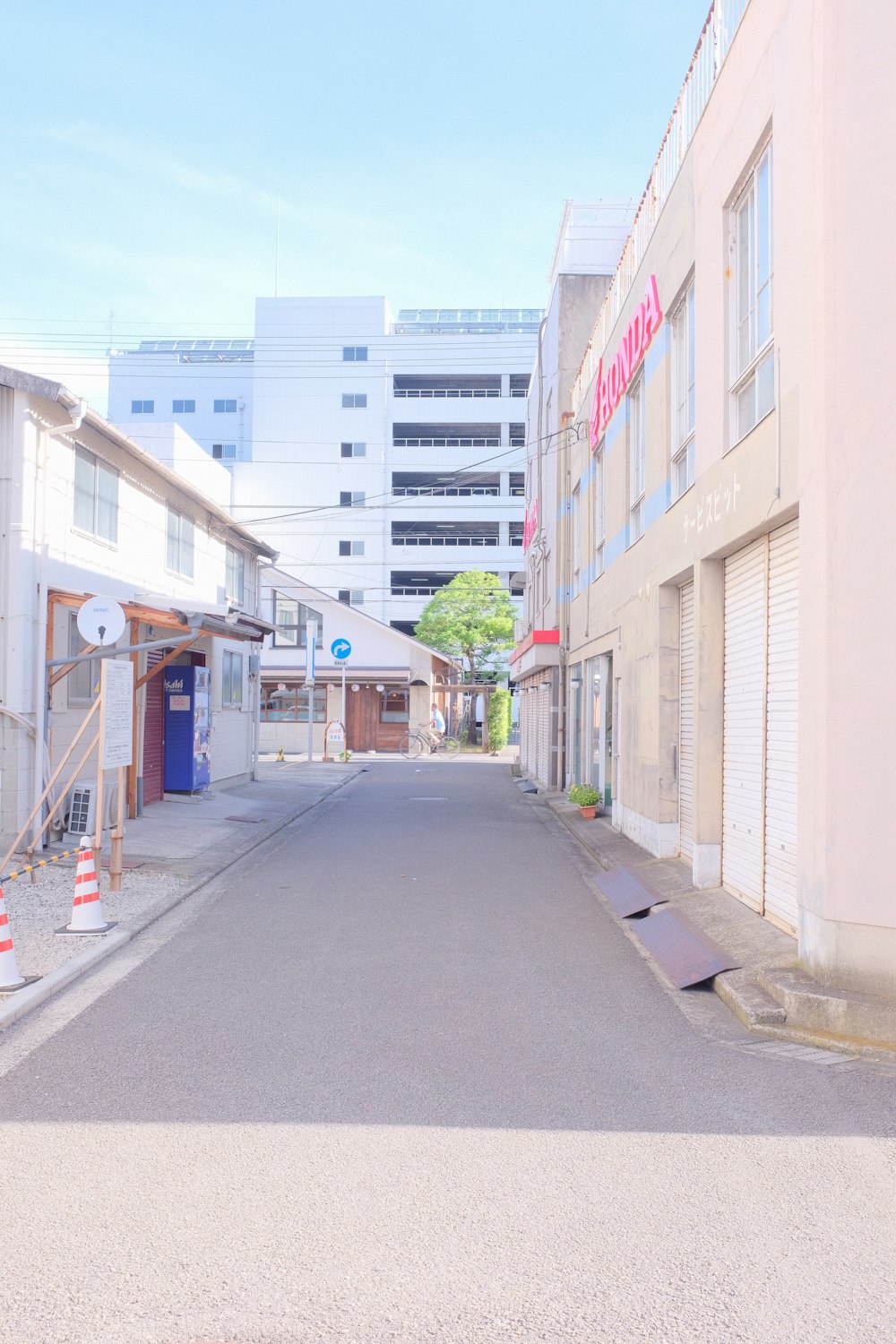 gray concrete road between buildings during daytime