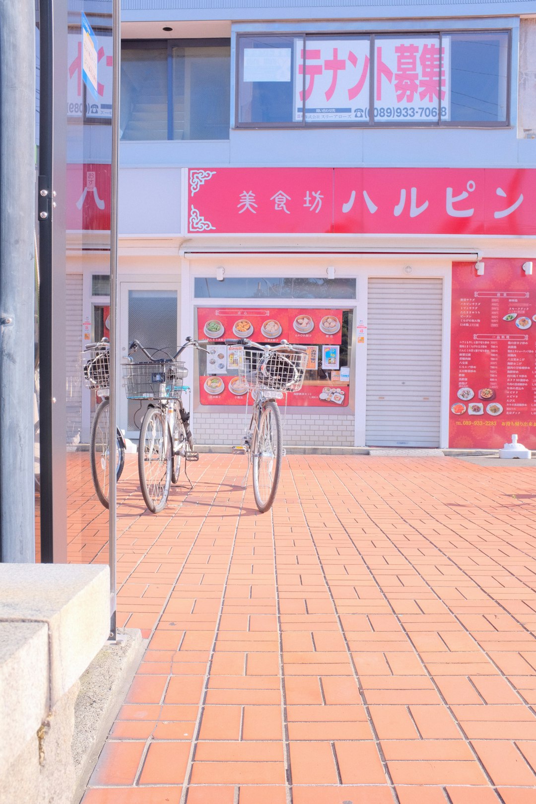 red and white bicycle parked beside red and white store
