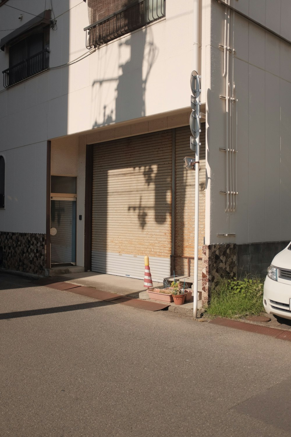 white car parked beside white building