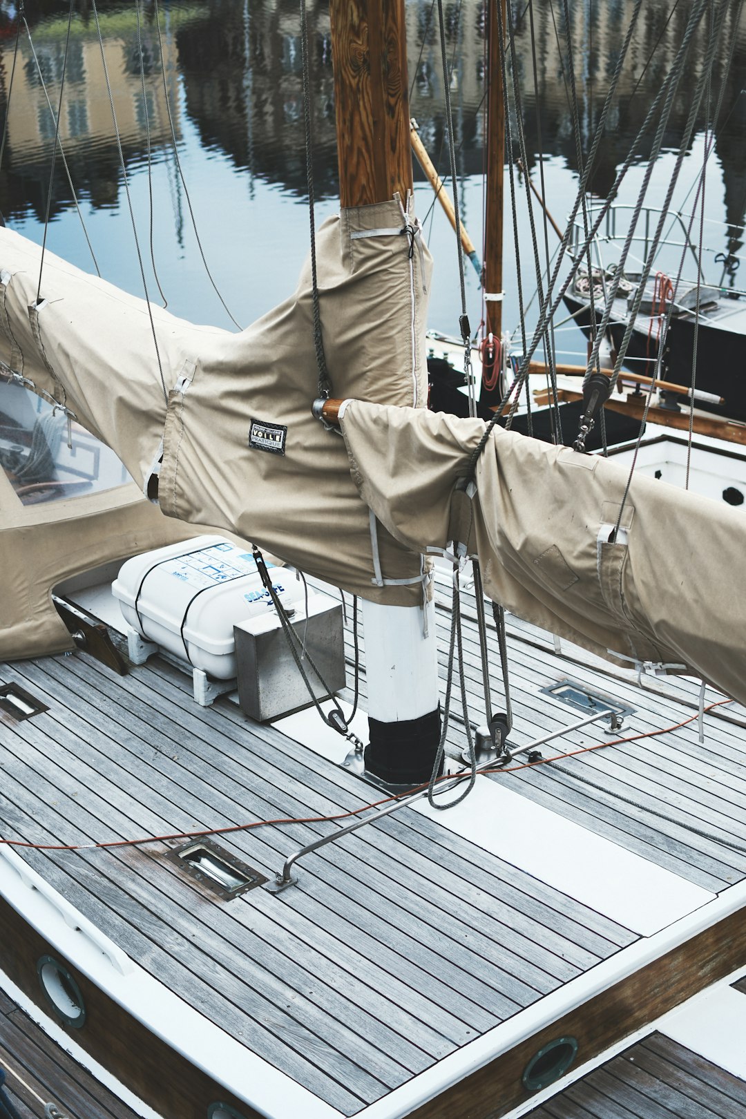 white and black sail boat on dock during daytime