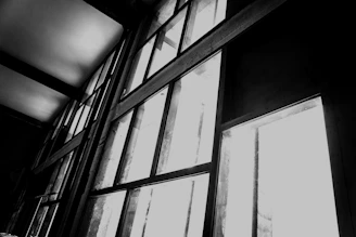 Modern aluminum door and window installation in a sleek black and gold themed interior.