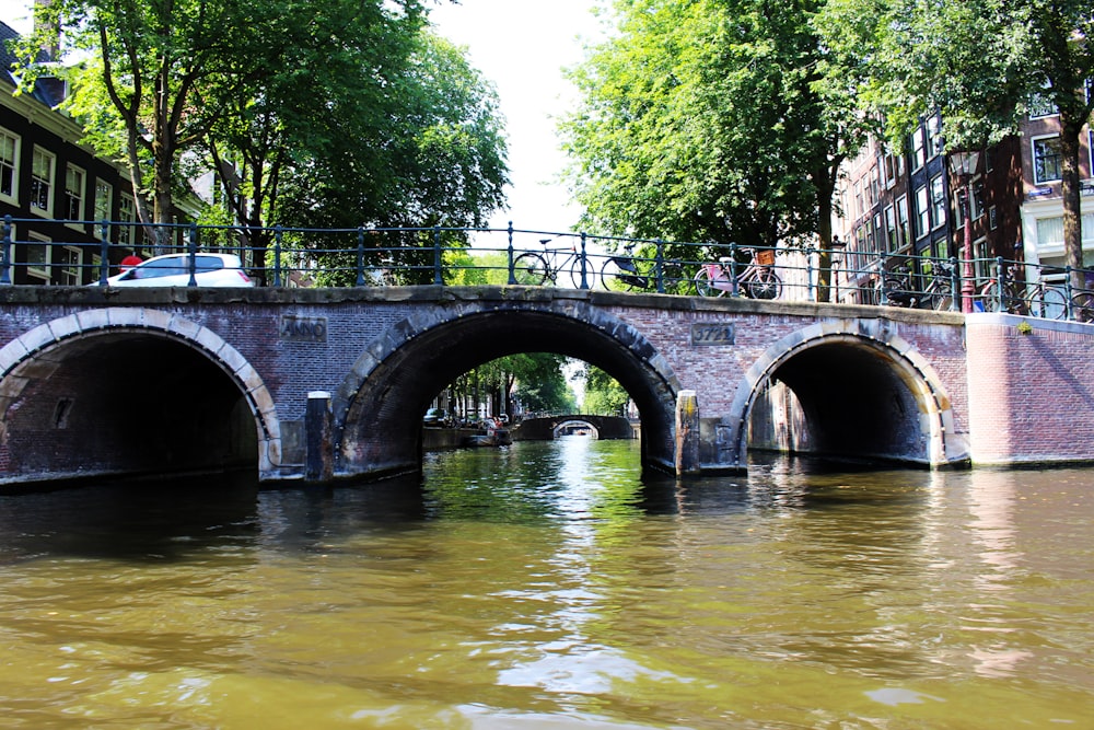 gray concrete bridge over river during daytime