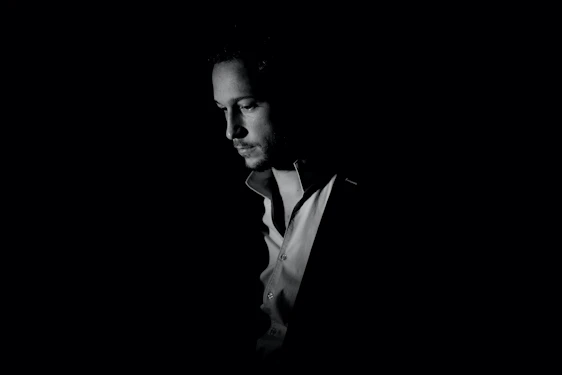 Black and white portrait of Eugen Mîrtz capturing a warm, introspective expression.