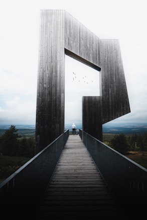 gray concrete bridge under white clouds during daytime