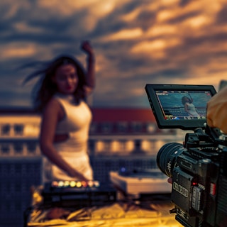 woman in white tank top holding black video camera for video production seattle wa