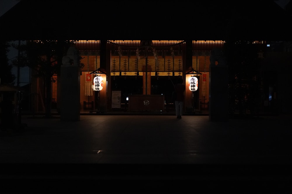 people walking on sidewalk during night time