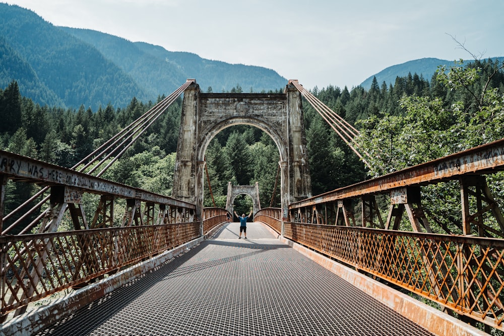 person walking on bridge during daytime