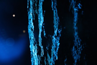 Artistic shot highlighting the interplay of dark blue shadows and golden light on the diosmooth™ handheld laser unit.