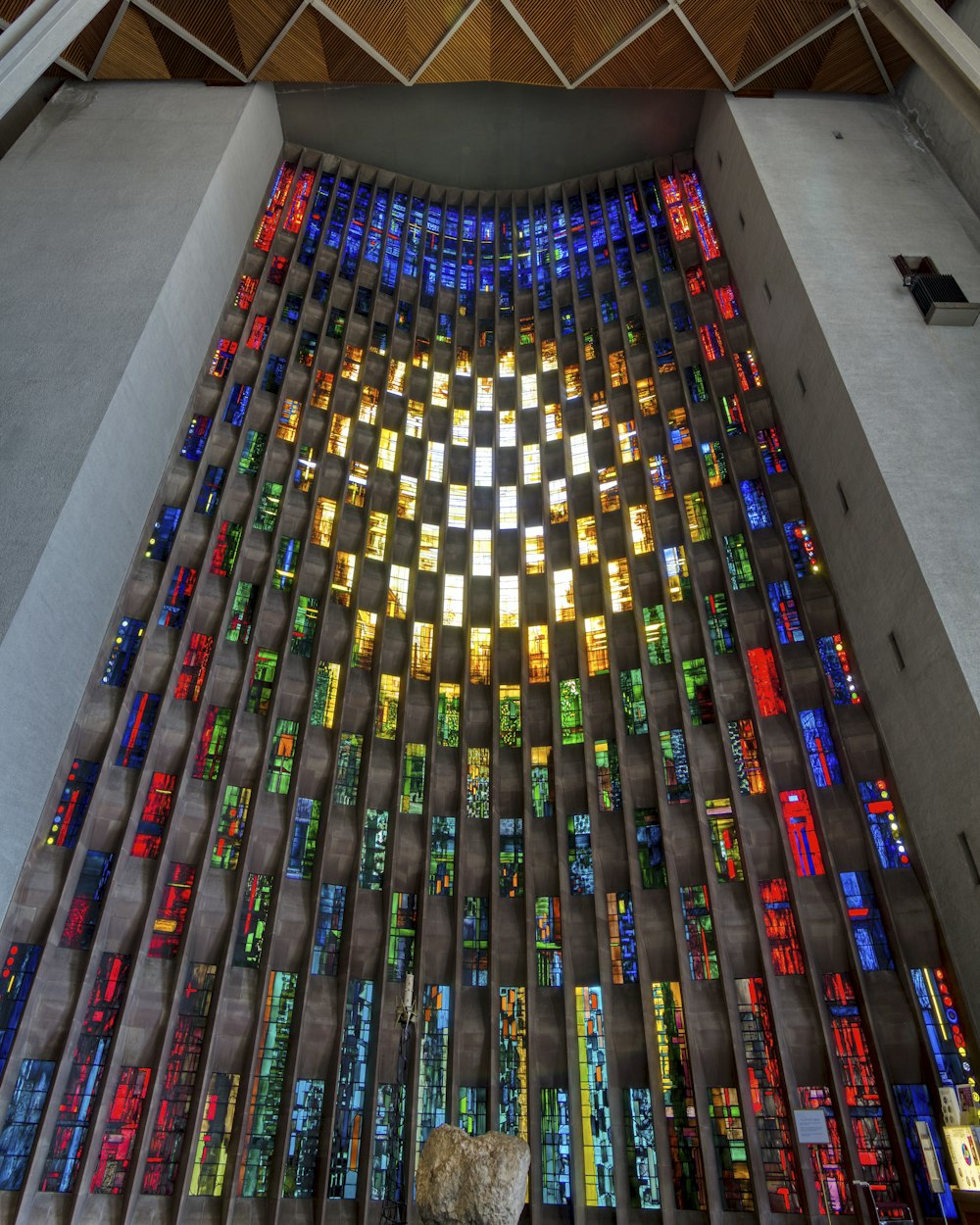 people walking on hallway with multi colored carpet