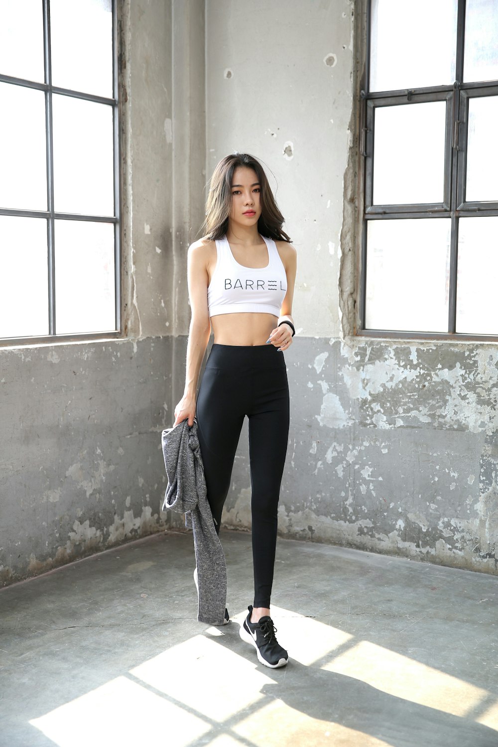 woman in white sports bra and black pants standing beside window during  daytime photo – Free Clothing Image on Unsplash