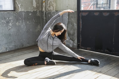 A relaxed person enjoying deep stretching exercises on a weekend morning in a bright, airy space.