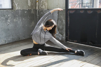 A serene moment of a man stretching in a bright Madrid apartment during a coaching session.