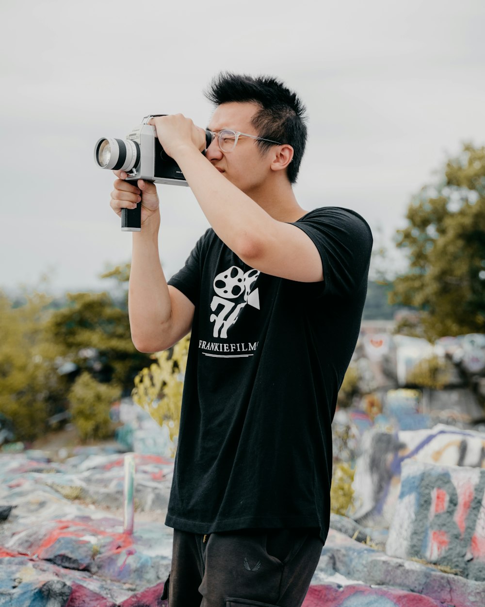 man in black crew neck t-shirt holding camera