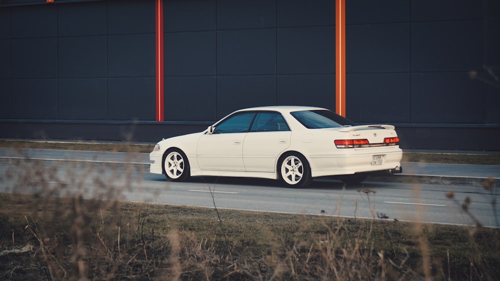 white sedan on gray asphalt road