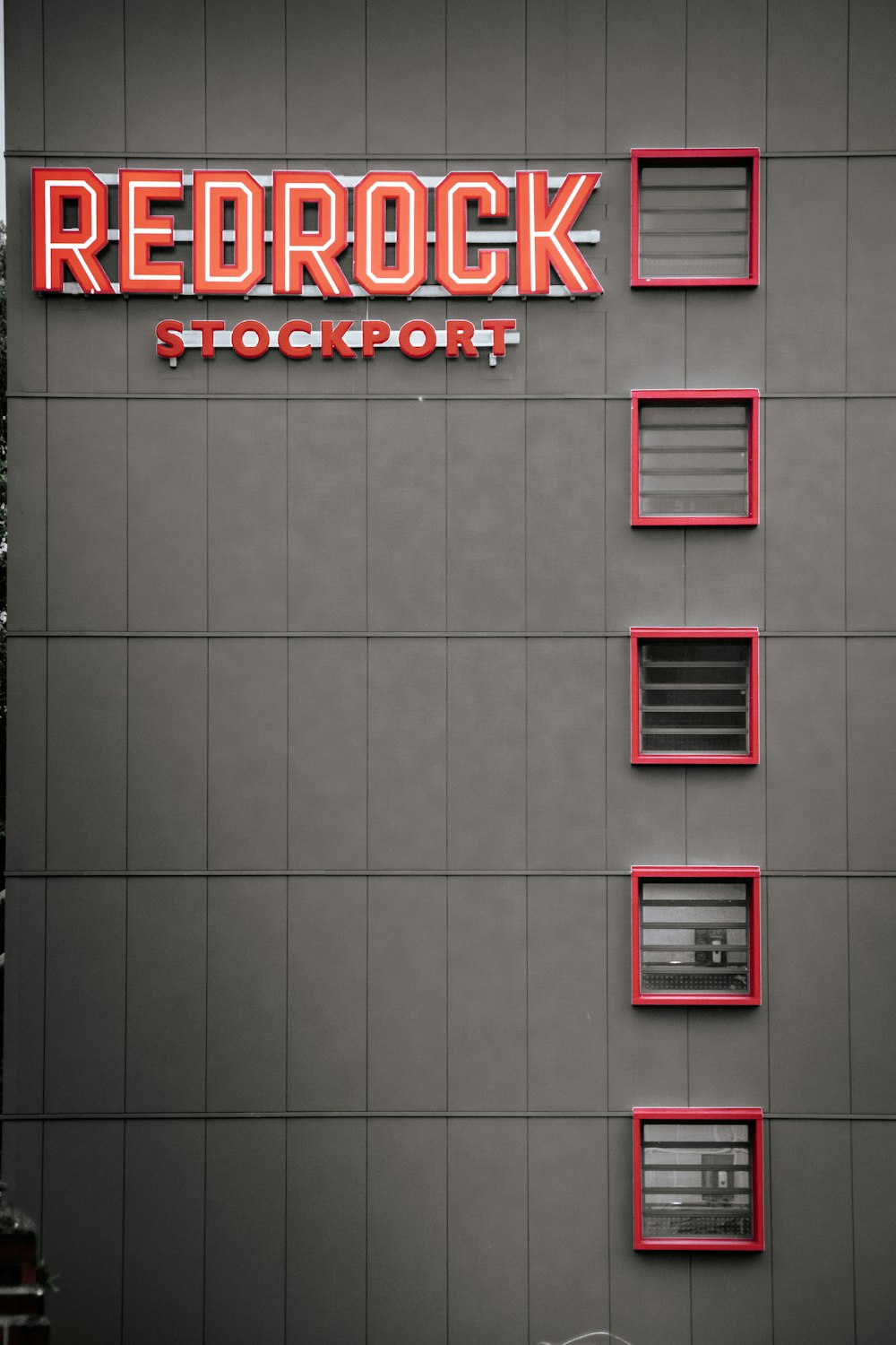 a building with a red brick sign on the side of it