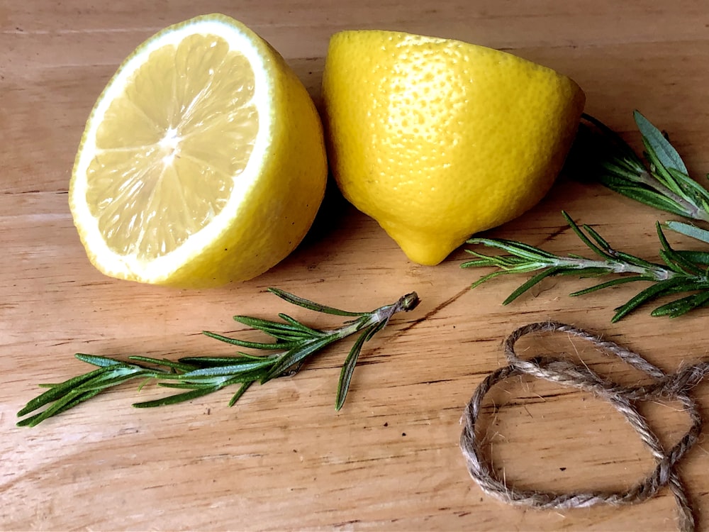 yellow lemon fruit on brown wooden table