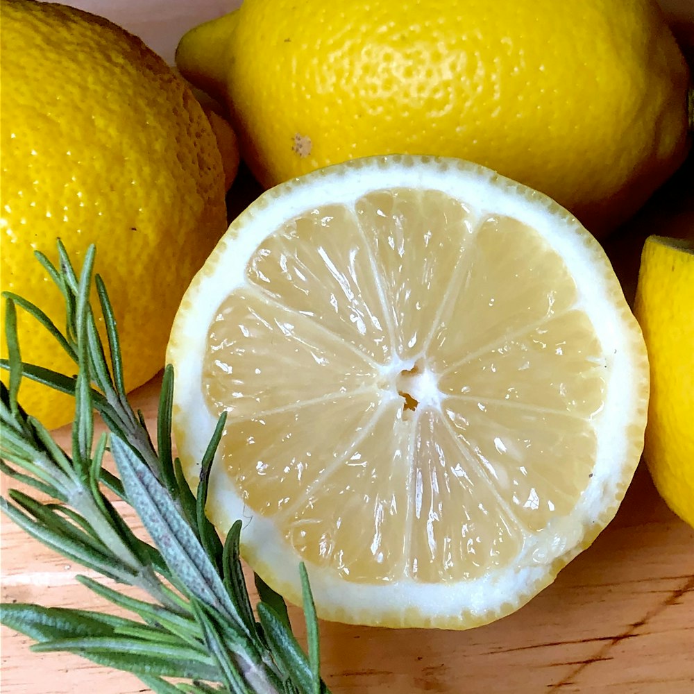 yellow lemon fruit beside green leaves