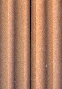 Close-up of stacked ship metal sheets with rust textures.