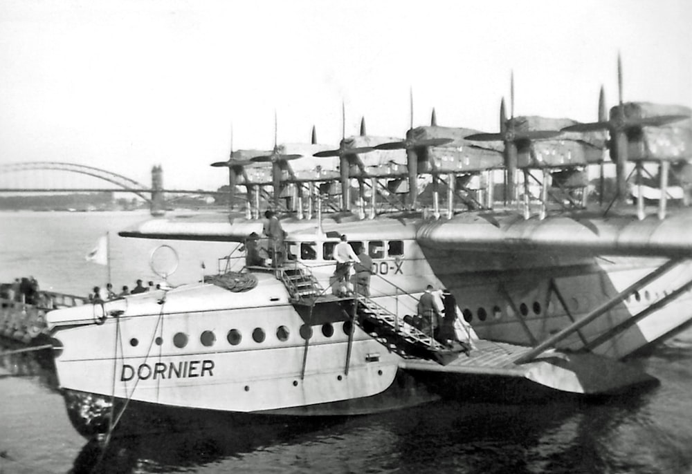 grayscale photo of white ship on sea