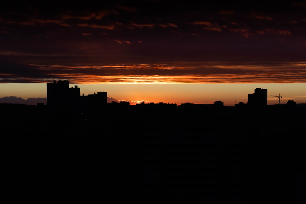 silhouette of city buildings during sunset