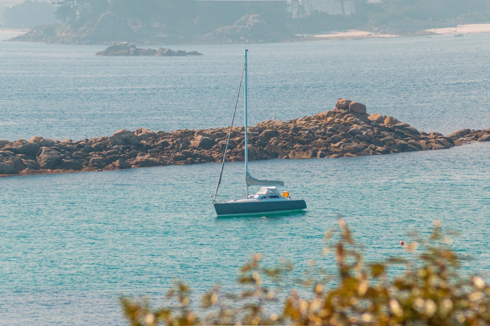 white and blue boat on sea during daytime