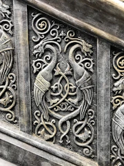 An intricate Celtic knot entwined with mythical creatures under a twilight sky.
