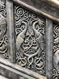 Intricate design featuring feathers and milagros.