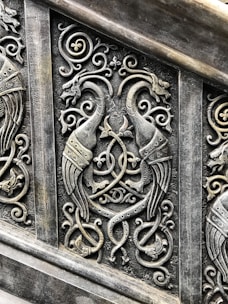 Intricate design featuring feathers and milagros.