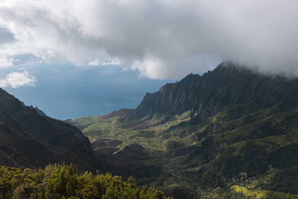 green and brown mountains under white clouds during daytime