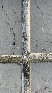 Close-up of pressure washing cleaning a stone pavement with water spray.